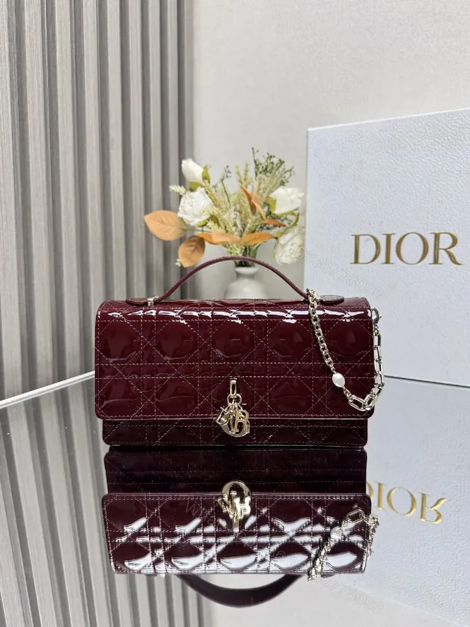 View 1 of Burgundy Patent Leather Clutch: Geometric Quilted Luxury