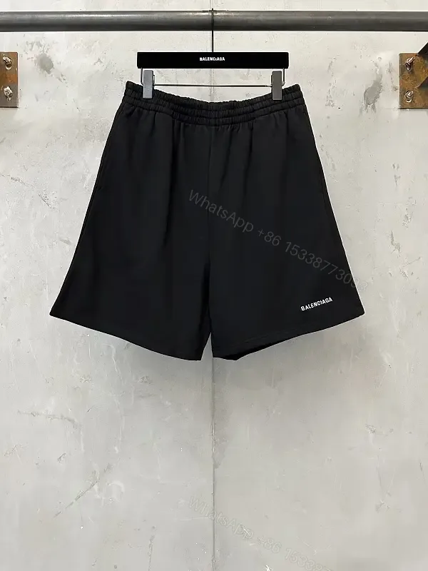 View 1 of black nylon shorts with logo motif for luxury everyday wear