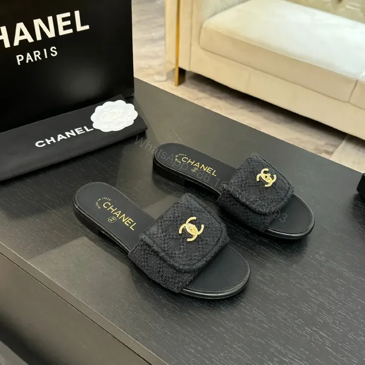 View 1 of Quilted Black Slip-Ons with Gold Logo – Luxury Comfort
