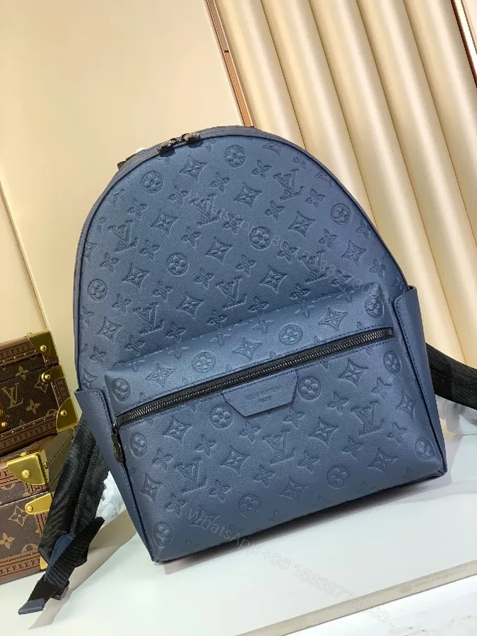 View 1 of Compact Monogram Backpack: Textured Luxury, Everyday-Ready