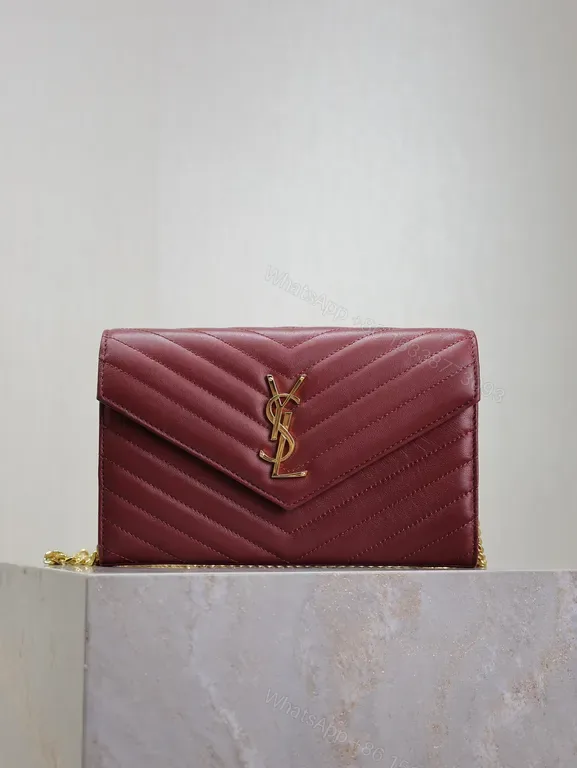 View 1 of Burgundy Quilted Envelope Crossbody Bag with Gold YSL Logo