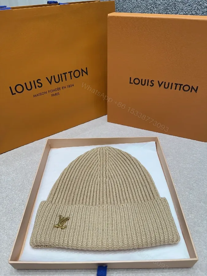 View 1 of Textured Camel Knit Beanie with Gold Crest - Cozy Luxury Style