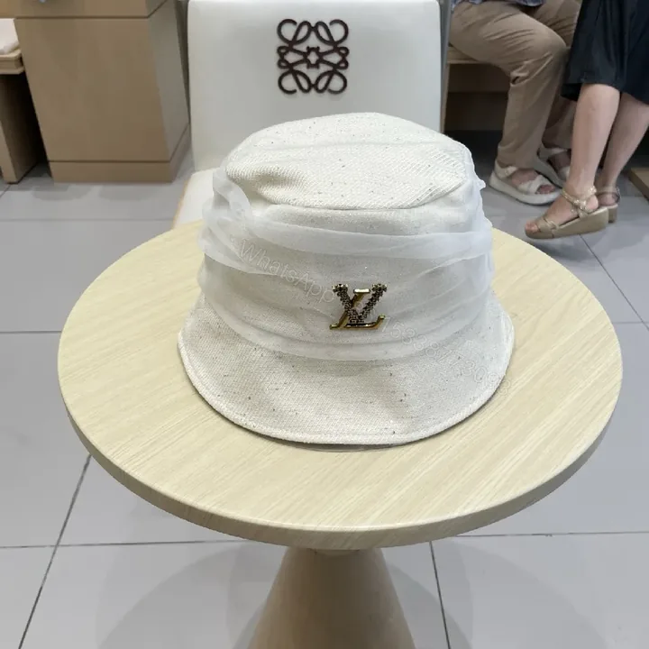 View 1 of Chic White Knit Bucket Hat with Gold Accent