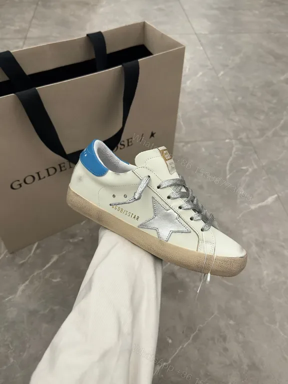 View 1 of Premium Off-White + Leather Sneaker with Blue Heel & Star Details