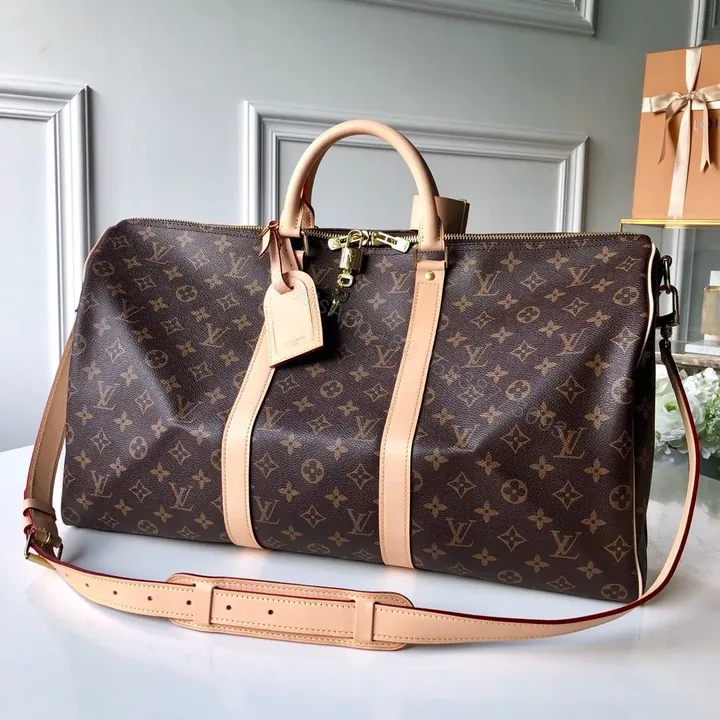 View 1 of LV Monogram Canvas Keepall Bandoulière 55 Leather Duffle Bag