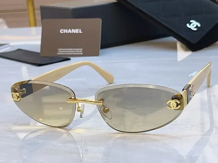 View 1 of Luxurious Silver-Gray Sunglasses: Gold Accents, Semi-Rimless Oval, Chanel Hardware
