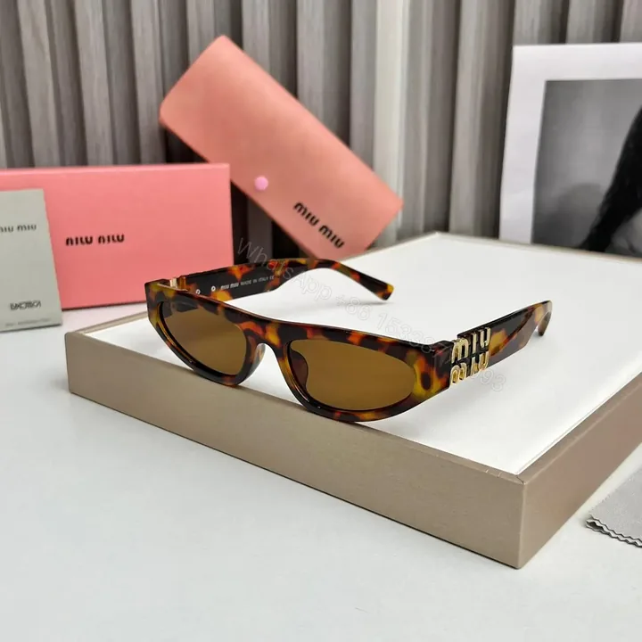 View 1 of Miu Miu Cat Eye Brown Print Sunglasses – One Size