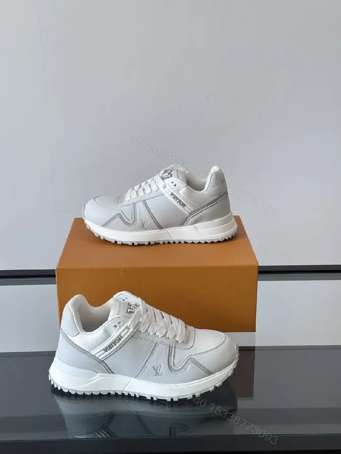 View 1 of Minimalistic White Leather Sneakers with Subtle Texture and Monogram Accent