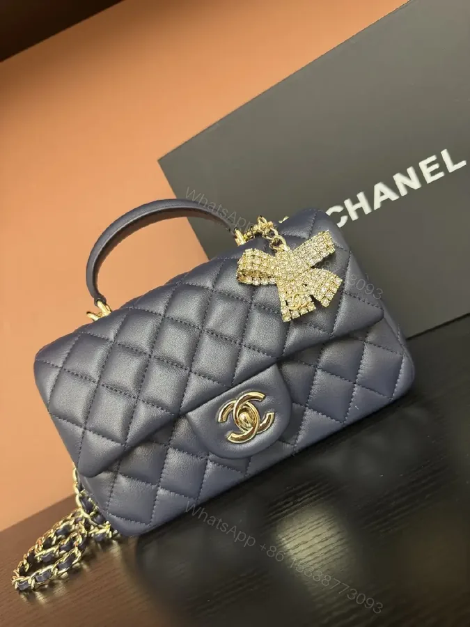 View 1 of Quilted Leather Mini Bag with Gold Emblem - Compact Glamour