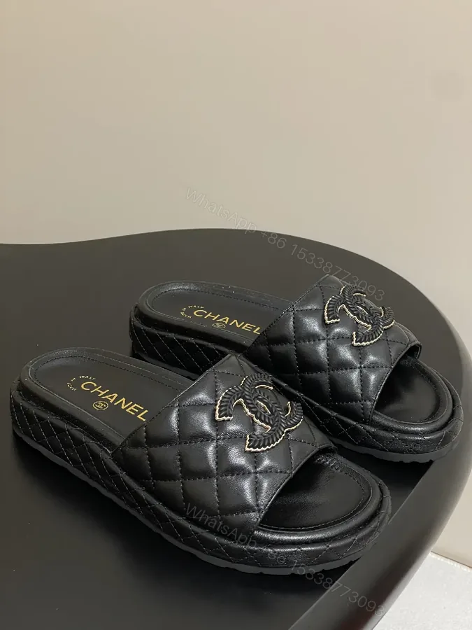 View 1 of Quilted Black Slip-Ons with Gold Emblem – Luxe Style