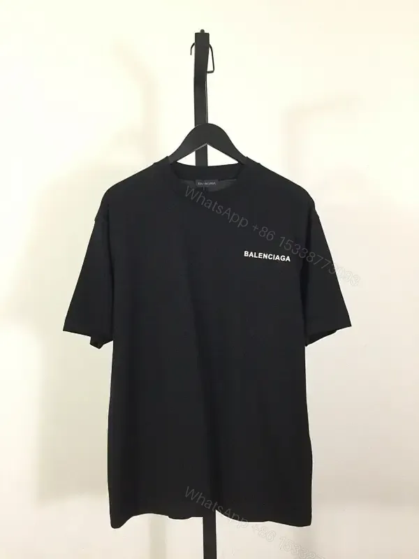 View 1 of Minimalist Black Mockneck Tee: Premium Cotton, Subtle Logo, Versatile Style