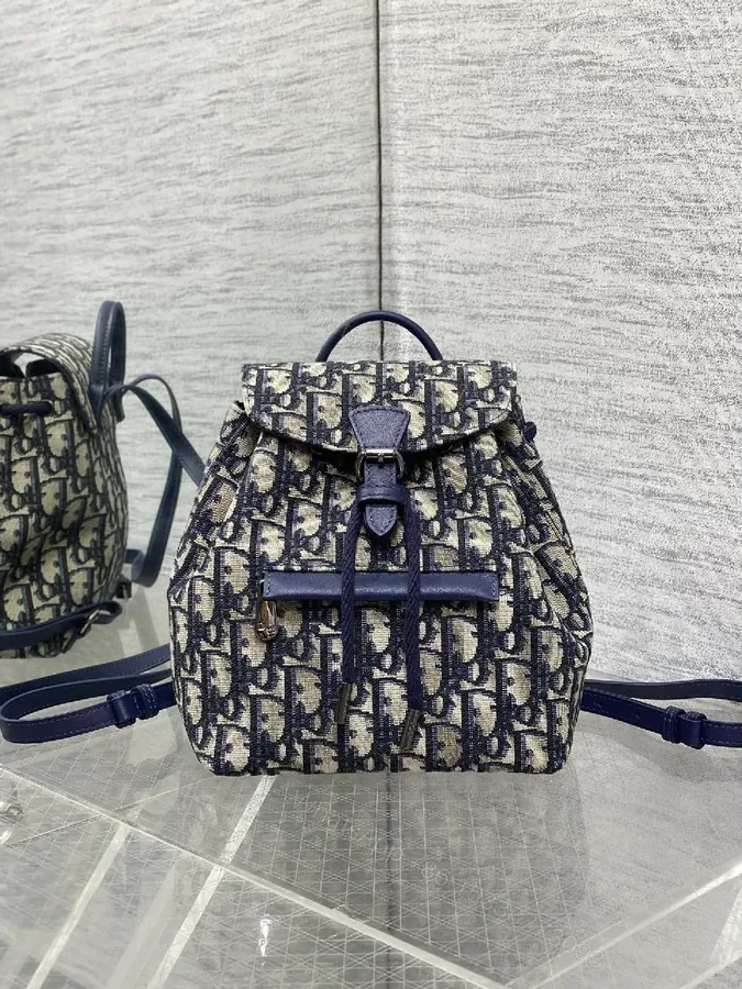 View 1 of Navy Canvas Monogram Compact Backpack with Leather Accents