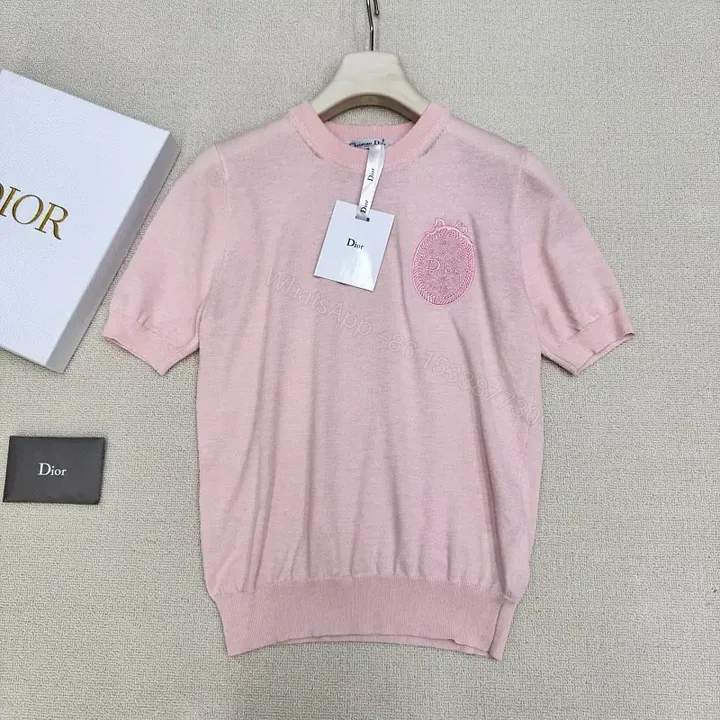 View 1 of Soft Pink Knit Top with Crest – Elegant Everyday Essential
