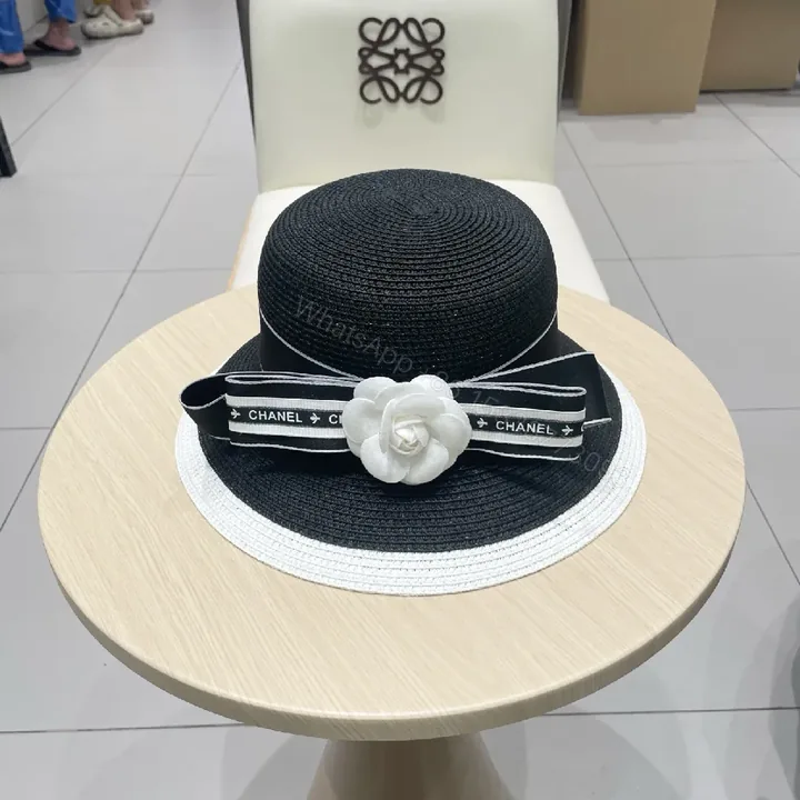View 1 of Black-White Straw Hat with Ribbon Flower Accent - Sun Ready Couture-style Hat