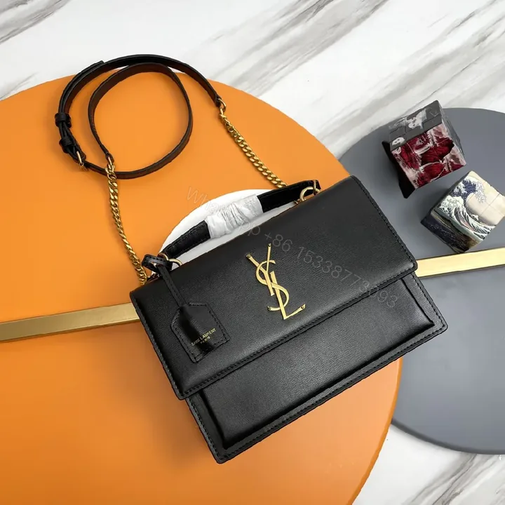 View 1 of Chic Black Leather Crossbody with Gold Emblem: Compact Luxury