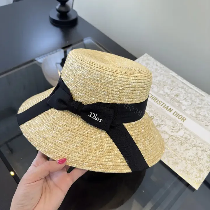View 1 of Natural Straw Wide-Brim Hat with Black Ribbon Accent
