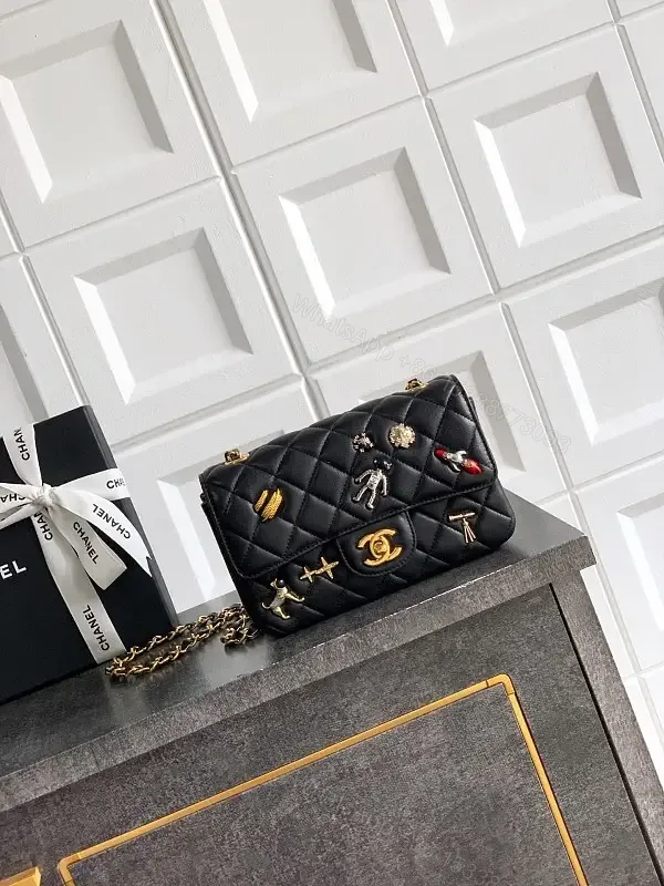 View 1 of Quilted Black Leather Crossbody: Golden Turn-Lock Charm Bag