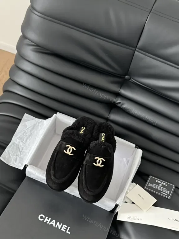 View 1 of Chanel-Inspired Black Shearling Mules with Gold Logo Detail