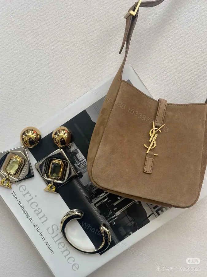 View 1 of Soft Suede Crossbody Bag with Gold Accent Emblem - Compact Style