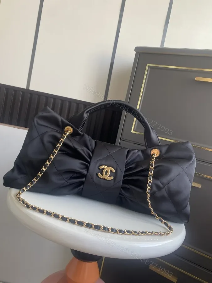View 1 of Quilted Black Bag with Gold Emblem - Luxury Everyday Style