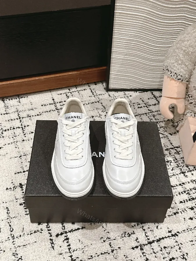 View 1 of Minimalist White Leather Sneakers with Subtle Chanel Detailing