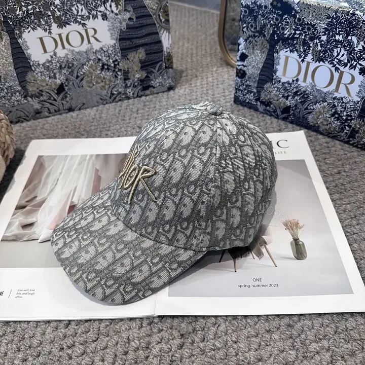 View 1 of Gray Monogram Textured Cap with Gold Dior Embellishment