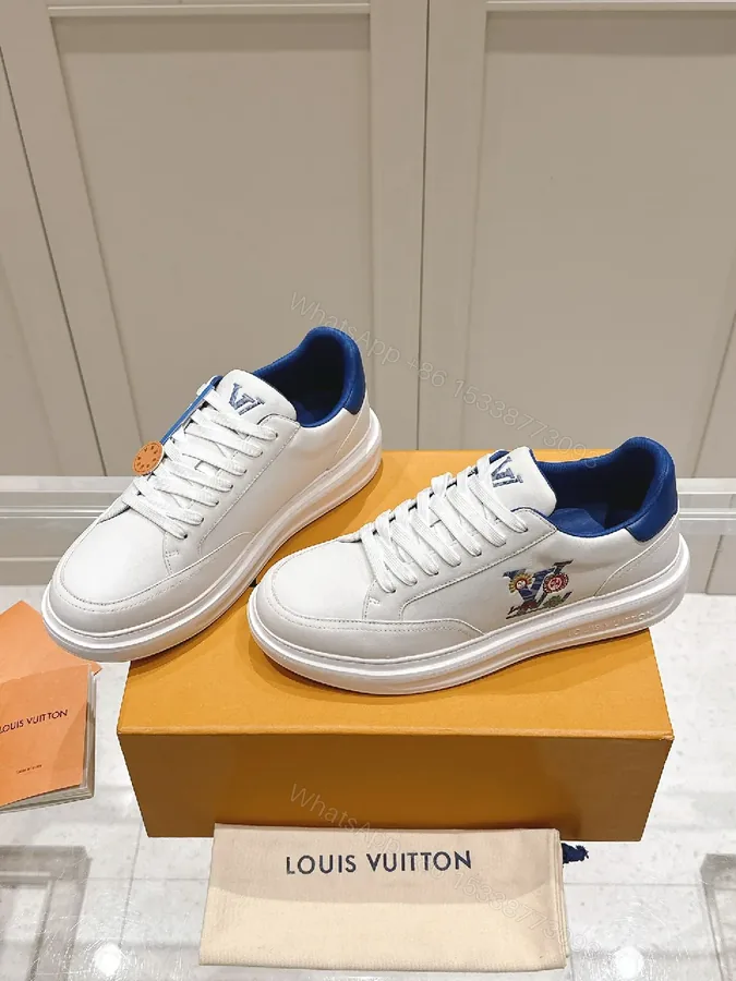 View 1 of Clean White Leather Low-Top Sneakers with Subtle Designer Embellishments