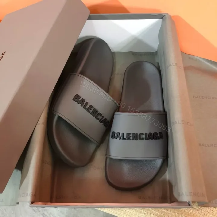 View 1 of Minimalist Designer Slides in Neutral Faux Leather with Bold Logo Strap