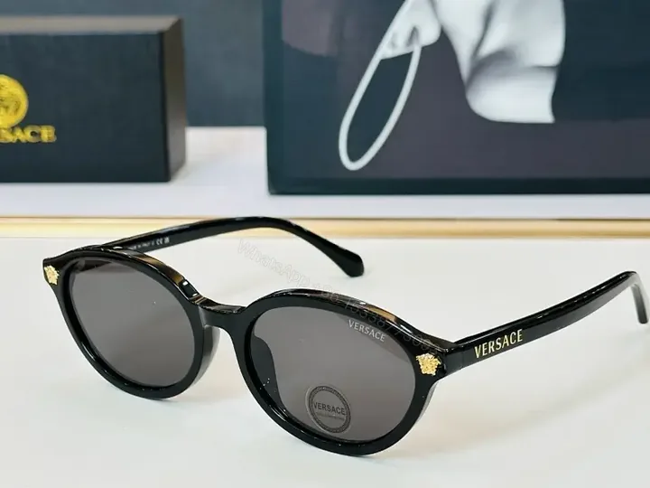 View 1 of Glassy Black Round Sunglasses with Gold Accents, UV400 Protection