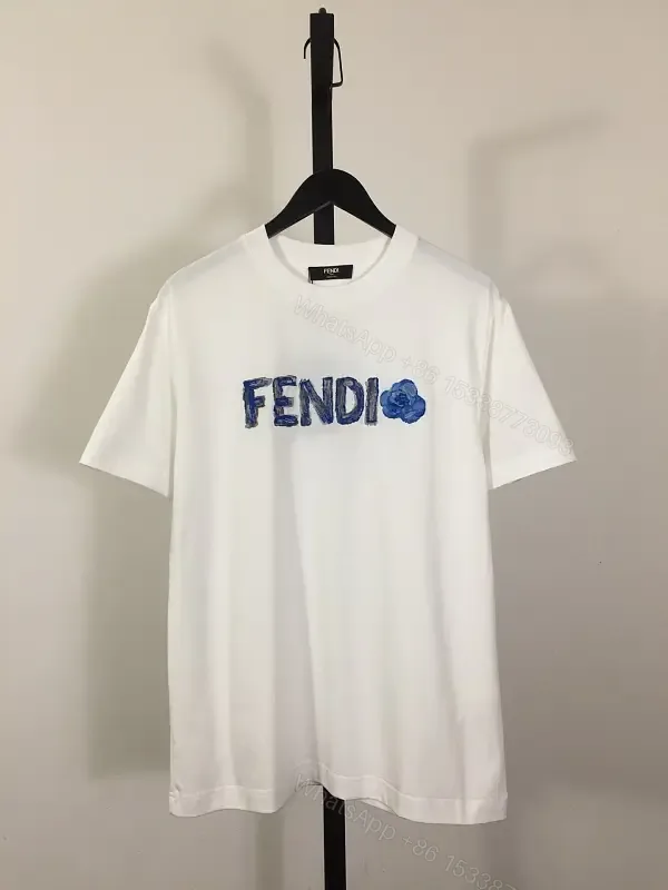 View 1 of White Cotton/Poly blend Short-sleeve Crew Neck Bold FENDI logo with blue flower T-shirt