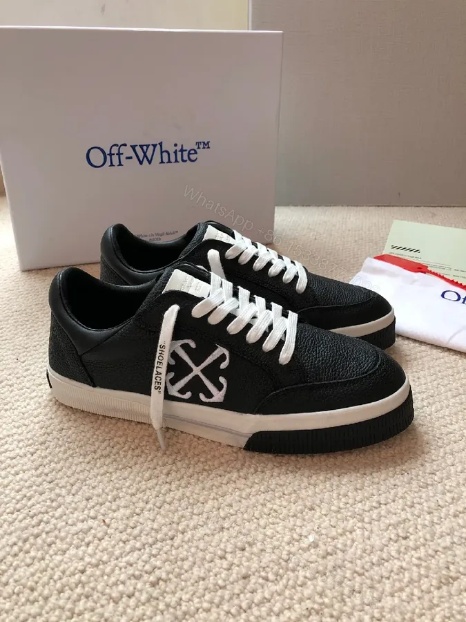 View 1 of Low-Top Black Pebbled Leather Sneakers with Signature Detailing