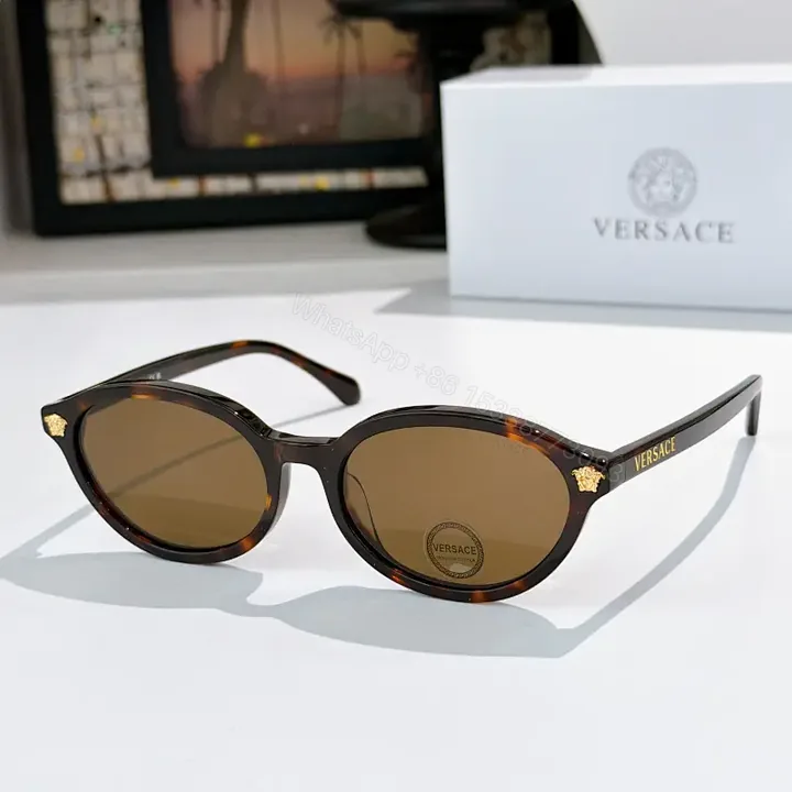 View 1 of Tortoiseshell Round-Frame Sunglasses with Gold Crest Accents