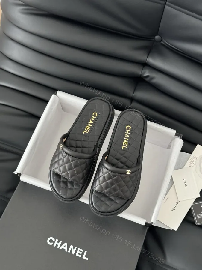 View 1 of Quilted Black Slip-Ons with Gold Logo - Luxe Comfort Shoes