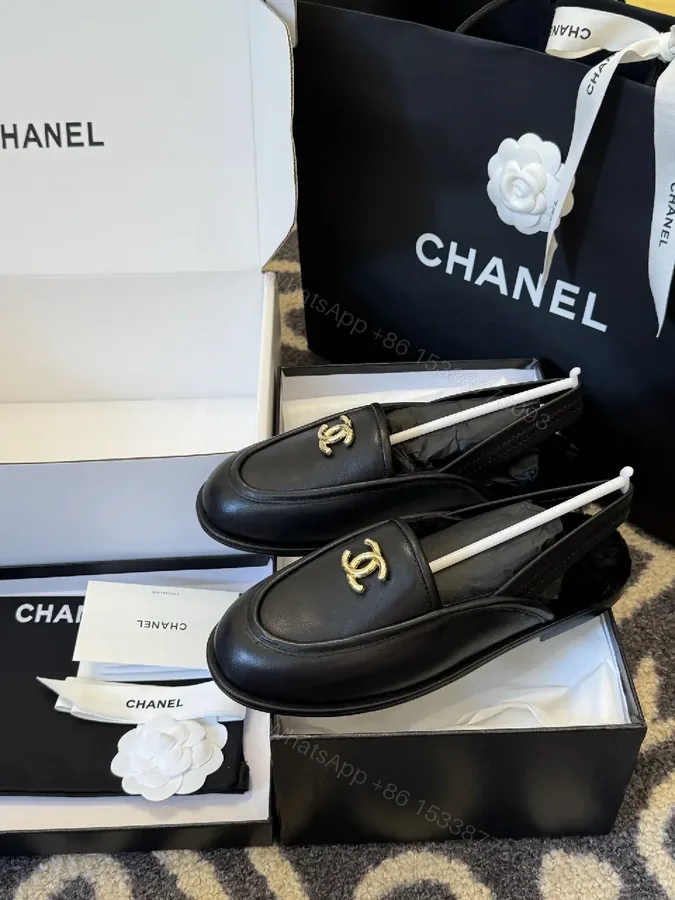 View 1 of Sleek Leather Loafers: Timeless Chic with Gold Logo Hardware
