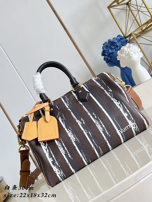 View 1 of Brown leather handbag with striped monogram pattern for luxury everyday use