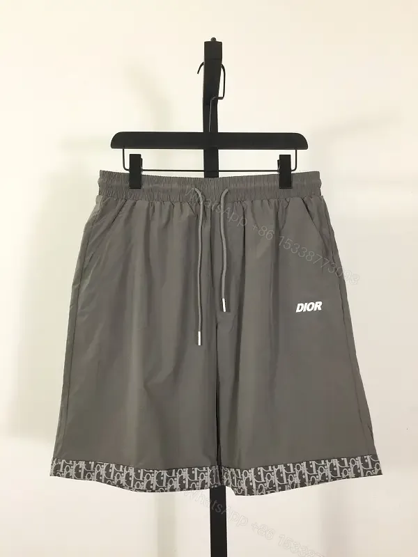 View 1 of Gray Nylon Bermuda Shorts Dior Logo Clip Hem Trim