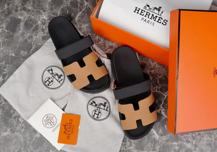 View 1 of Hermes Oran Leather Slides â€” H-Cutout, All-Day Comfort, Black/Tan