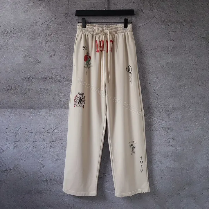 View 1 of Beige Wide-Leg Pants with Drawstring and Embroidered Patches