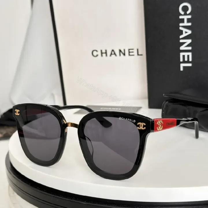 View 1 of Glossy Black Cat-Eye Sunglasses with Gold Accents & Red Temples