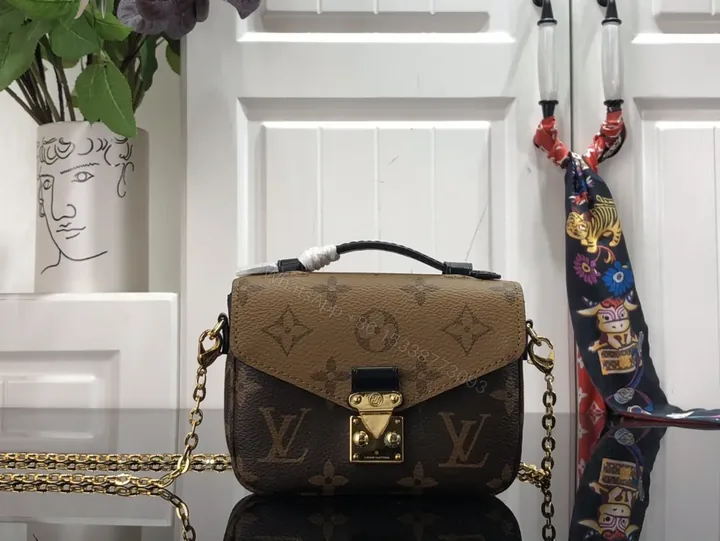 View 1 of Gold-Coated LV Monogram Crossbody Bag - Compact Luxury