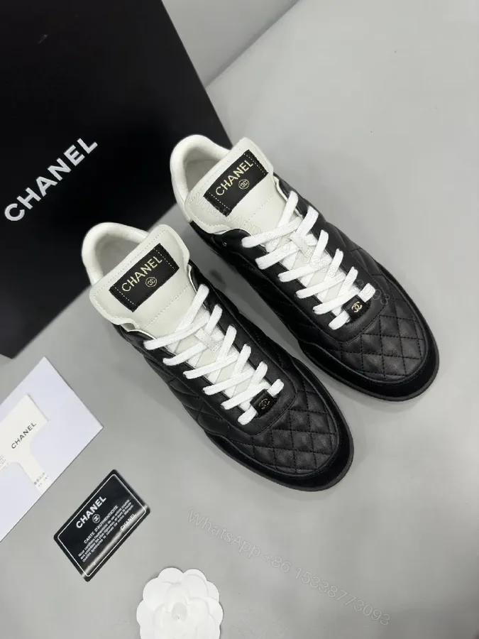 View 1 of Black-and-White Quilted Leather Sneakers with Luxe Hardware