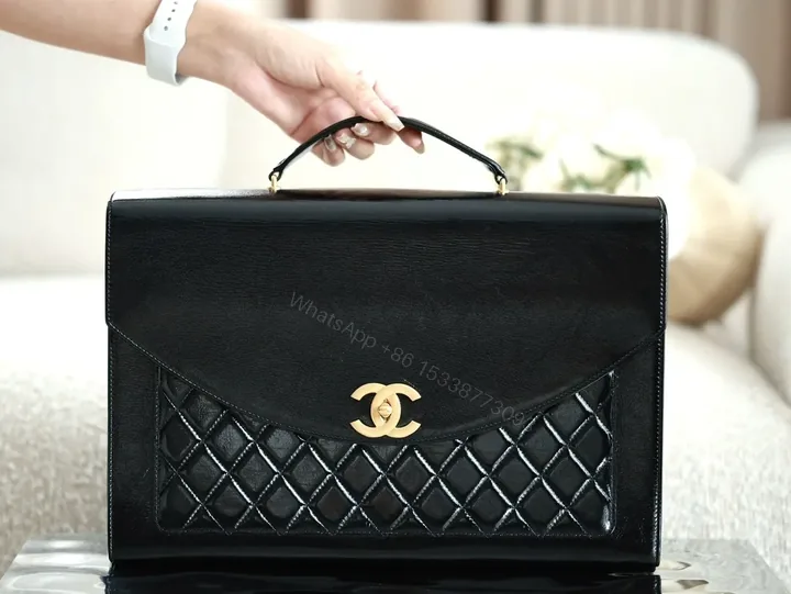 View 1 of Compact Quilted Leather Handbag with Gold Hardware
