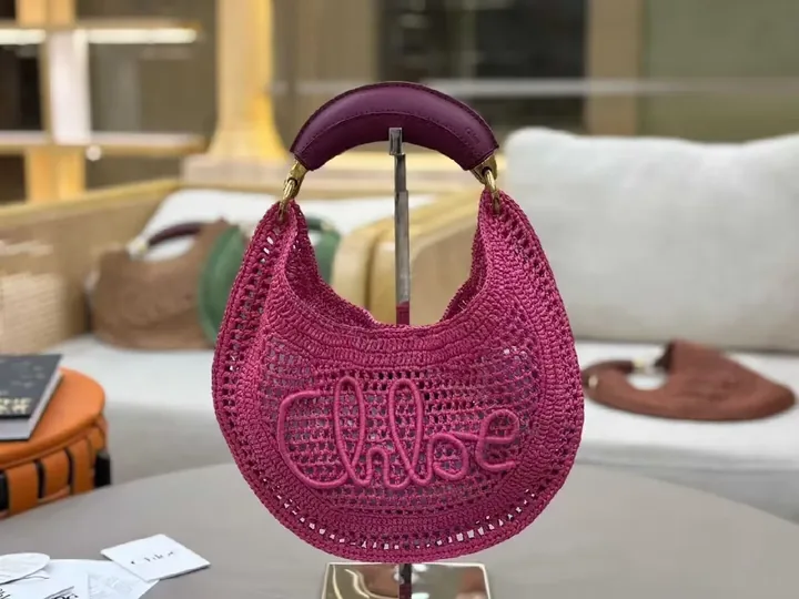 View 1 of Magenta Crochet Crescent Bag: Elegant, Compact, Textured Luxe