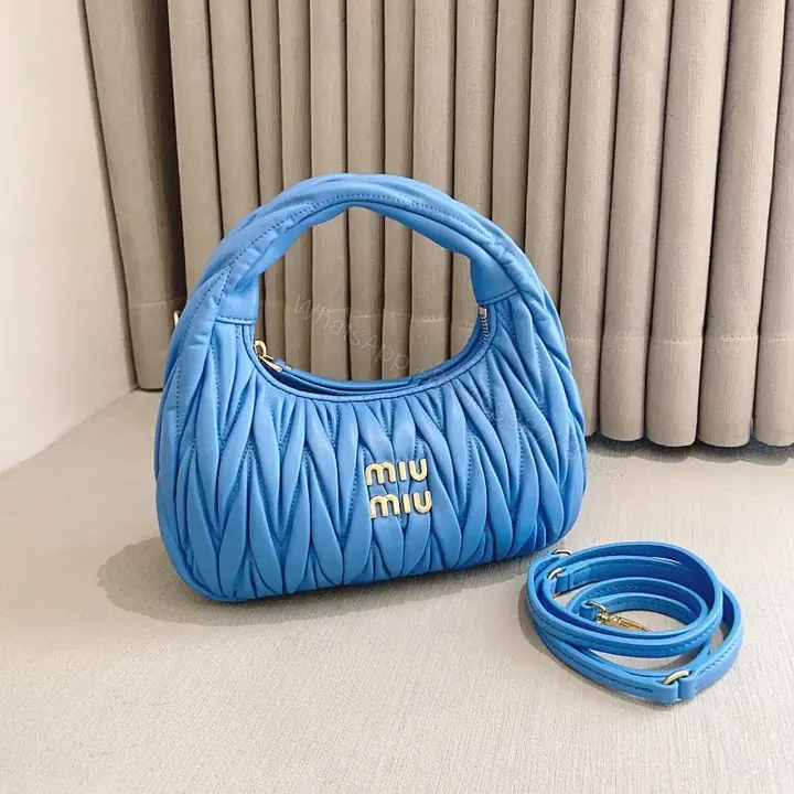 View 1 of Bright Royal Blue Quilted Crescent Handbag with Gold Miu Miu Logo