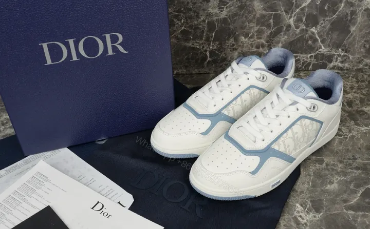 View 1 of Soft-White Leather Sneaker with Blue Accents and Signature Texture