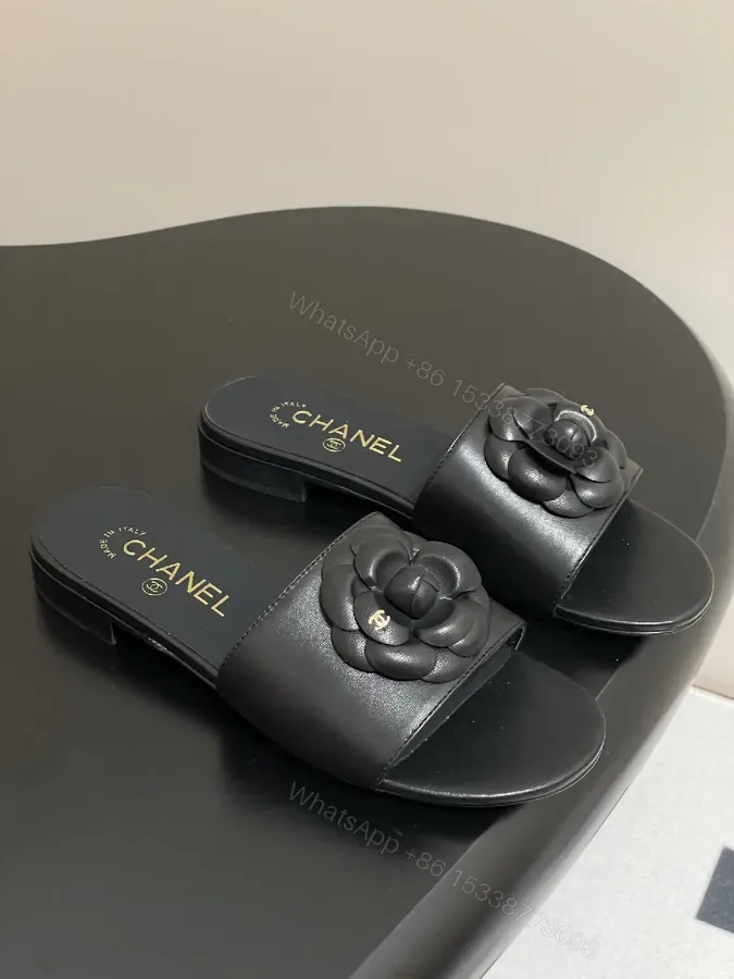 View 1 of Effortless Black Leather Slide with Camellia Detail