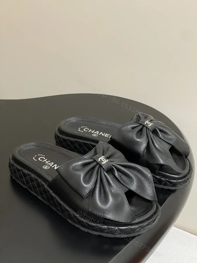 View 1 of Chic Black Quilted Slides with Bow Detail - Luxury Casual Platform