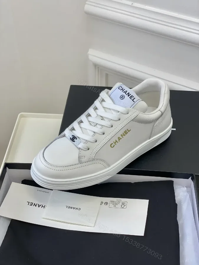 View 1 of White Leather Sneakers: Minimalist High-Tops with Gold Logo
