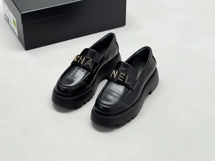 View 1 of Black Leather Chunky-Soled Loafers with Gold Monogram Band