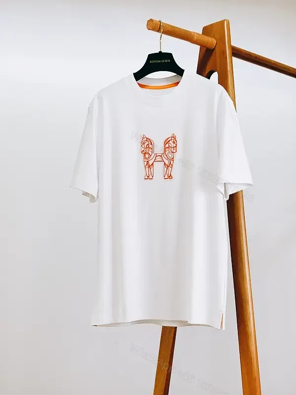 View 1 of Minimalist White Tee with Bold Orange Emblem T-Shirt